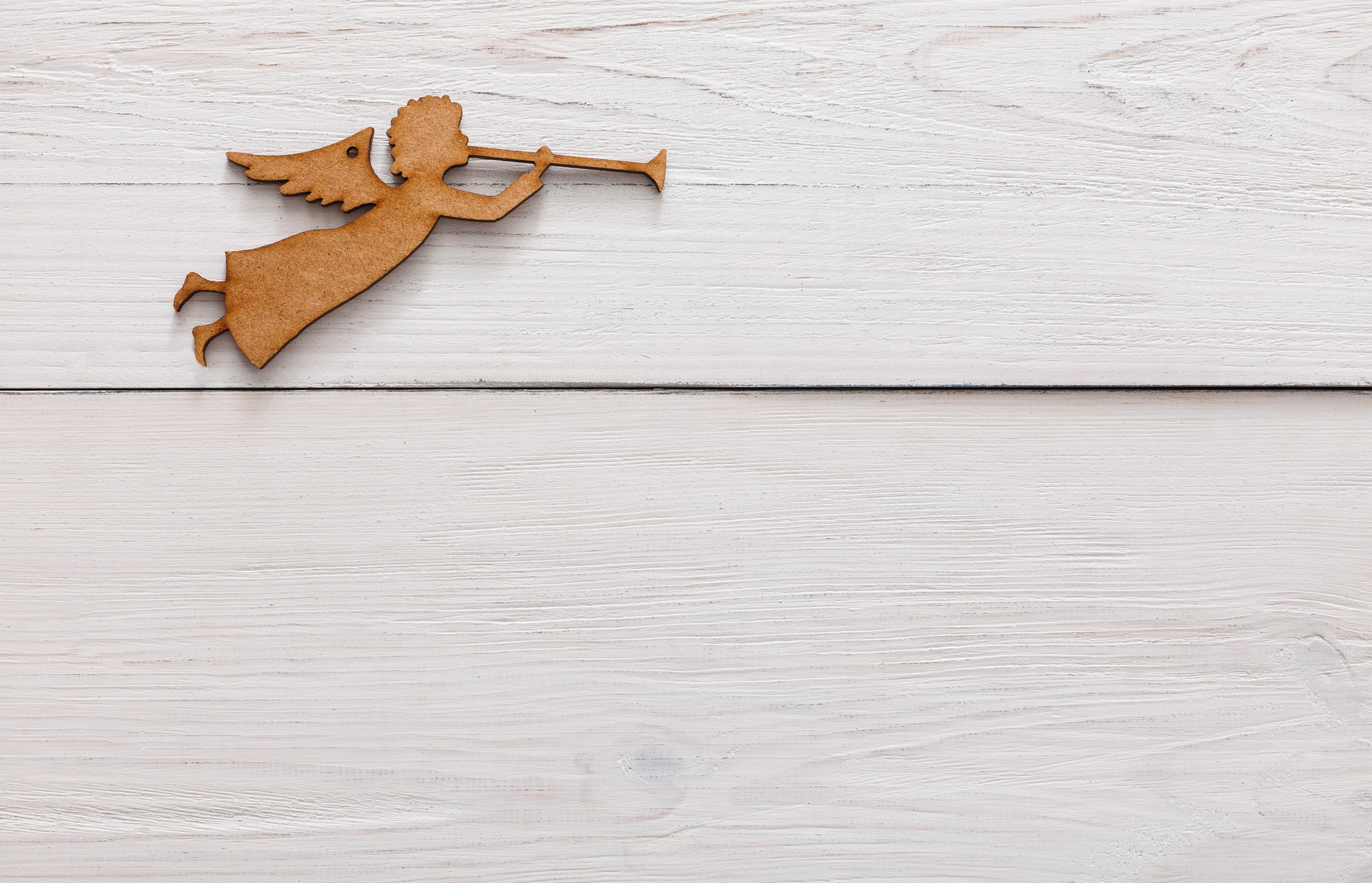 Christmas decoration angel on white wood background
