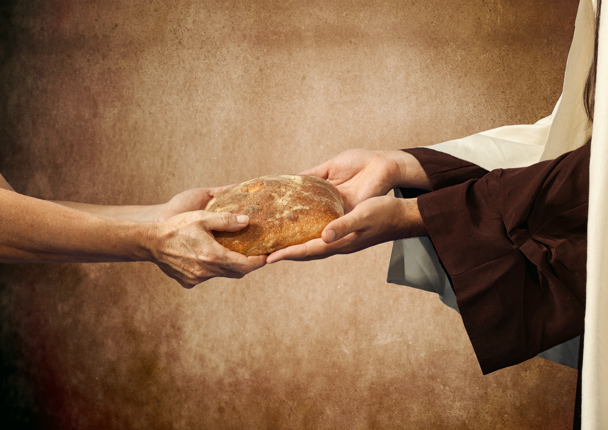 Jesus gives the bread to a beggar.