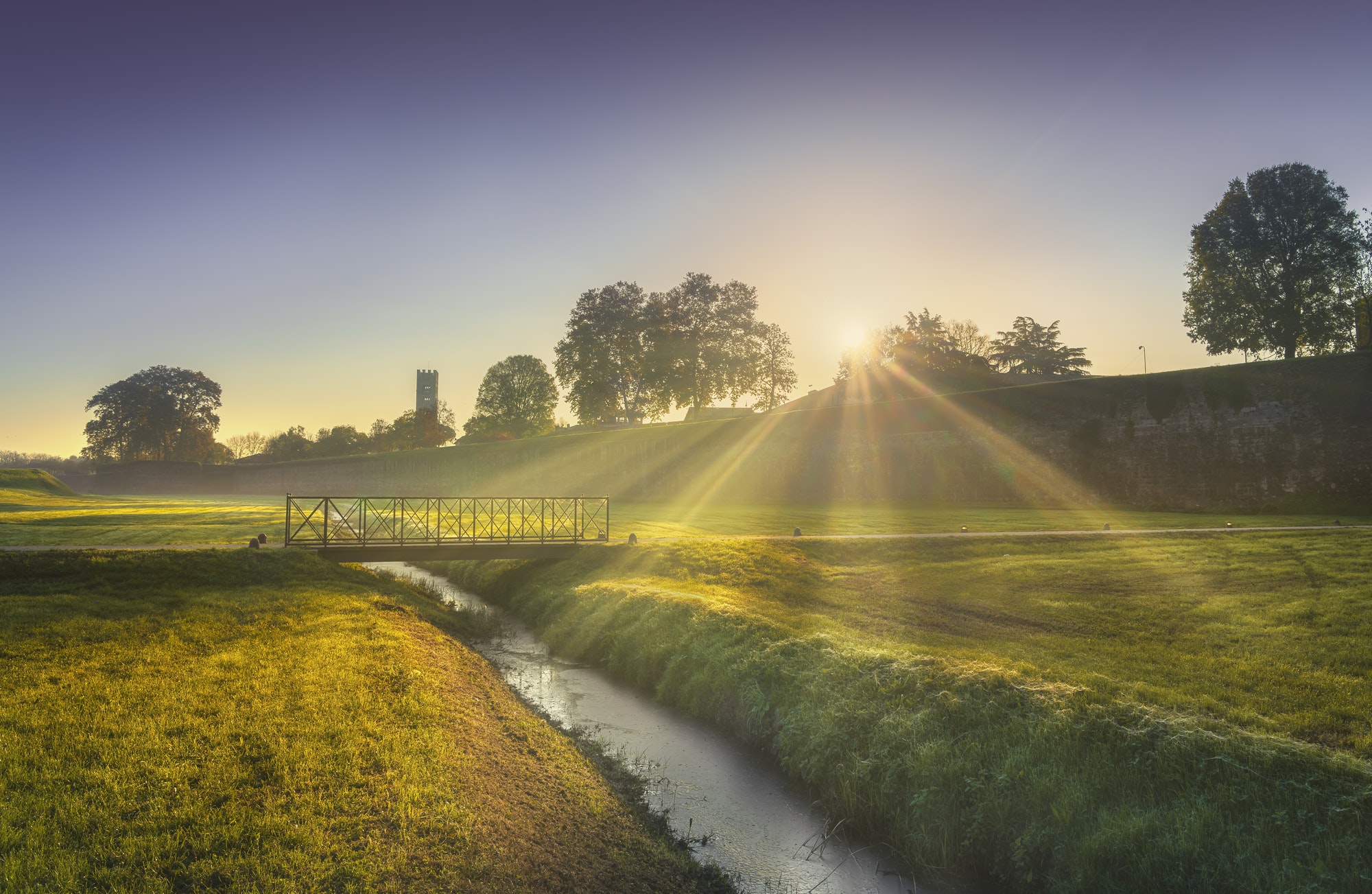 Lucca city walls and at sunrise. Tuscany, Italy